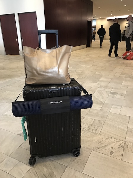 rimowa suitcase and yoga mat